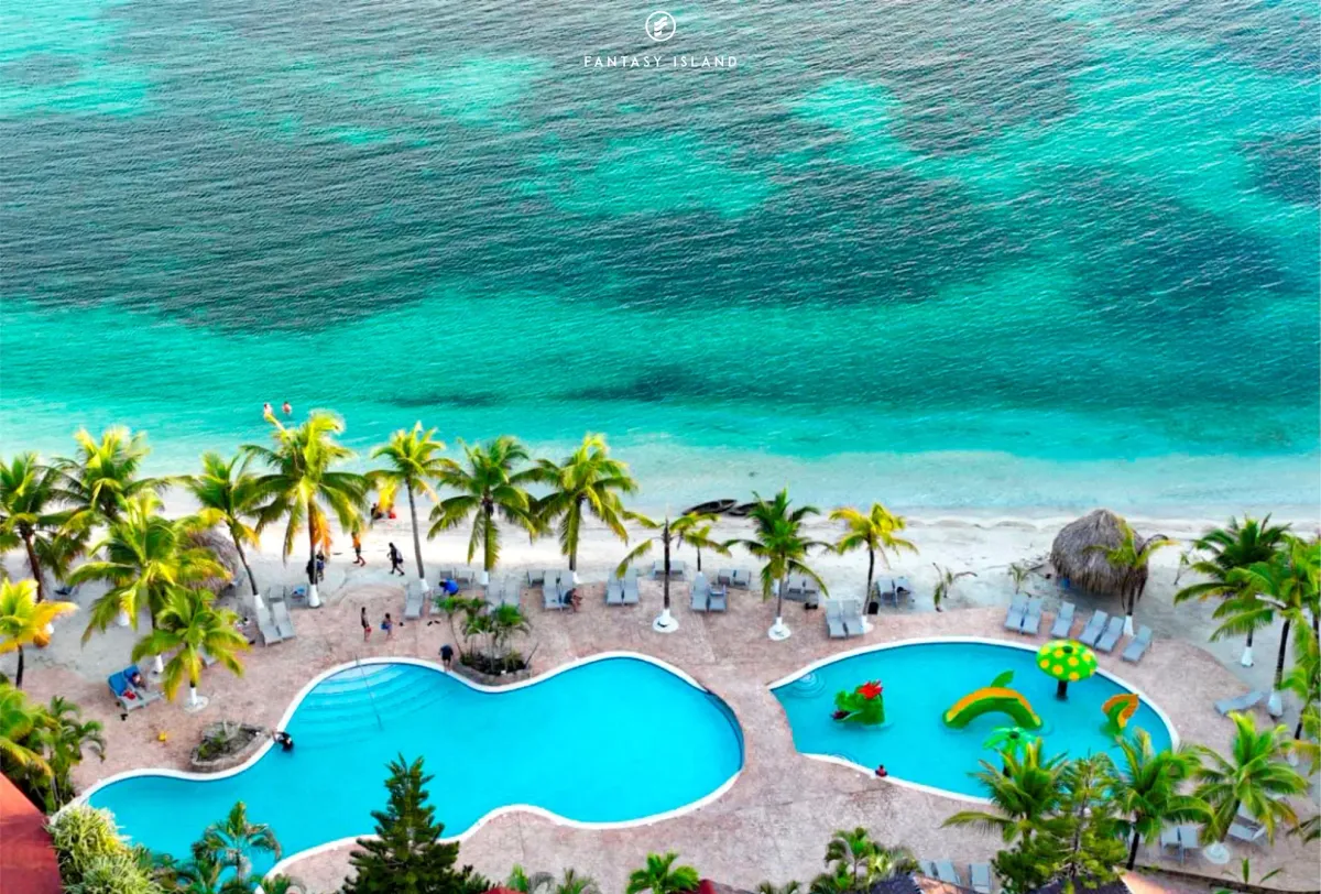 A West Bay beach club with pool and palms where the Roatan zip line tour ends